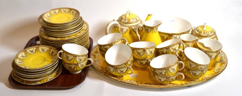 Lot 29 - A Royal Worcester gilt highlighted and yellow ground porcelain part tea service comprising oval...