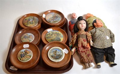 Lot 35 - Seven framed pot lids and four Chinese and Japanese dolls