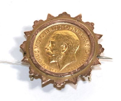 Lot 74 - A 1911 sovereign, loose mounted as a brooch