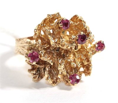 Lot 109 - A 9 carat gold textured ring set with rubies, finger size N