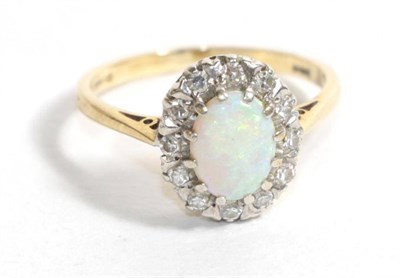 Lot 115 - A 9 carat gold opal and diamond cluster ring, finger size M1/2