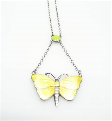 Lot 378 - A Butterfly Necklace, by Charles Horner, a green enamelled disk suspends a butterfly enamelled...