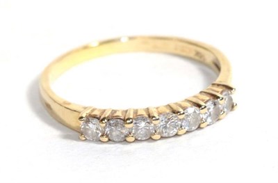 Lot 118 - A diamond half hoop ring, the round brilliant cut diamonds in yellow claws to a plain polished...