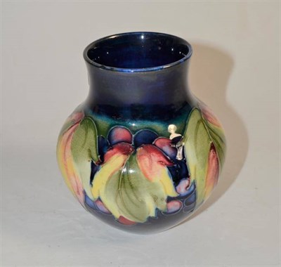 Lot 129 - A Moorcroft pottery grape and leaf pattern vase