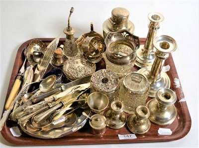 Lot 147 - An assortment of silver including fish slice, teaspoons, candle sticks, dressing table jars etc