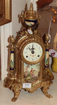 Lot 177 - A gilt metal striking mantel clock with decorated ceramic front panel