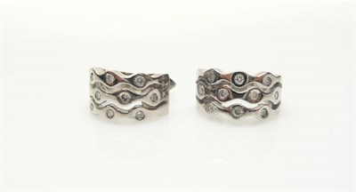 Lot 385 - A Pair of 18 Carat White Gold Diamond Set Cuff Earrings, a triple wavy spaced bar design, drill set