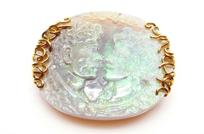 Lot 386 - An 18 Carat Gold Carved Opal Brooch, the oval cameo depicts the profiles of a male and a female...