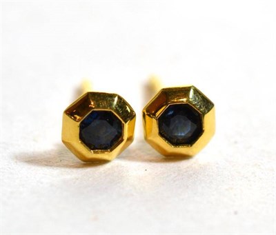 Lot 219 - A pair of 18 carat gold sapphire stud earrings, a round cut sapphire in an octagonal frame, measure