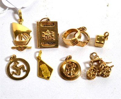 Lot 227 - Eight assorted charms including an 18 carat gold ship, a 9 carat gold dice, a carriage etc