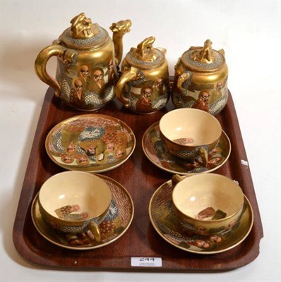 Lot 244 - A Japanese Satsuma part tea service decorated with sages, circa 1890/1900