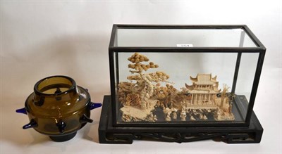 Lot 254 - A Japanese cork diorama depicting a pagoda within a landscape of trees, within a glass case,...