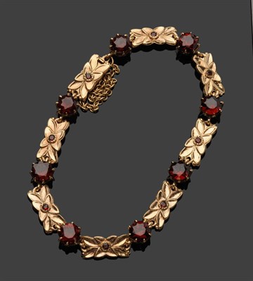 Lot 392 - A 9 Carat Gold Garnet Bracelet, by Bernard Instone, oblong floral motif panels each set with a...