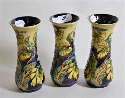 Lot 266 - Modern Moorcroft pottery: a set of three 'Comfrey' pattern vases from the herb collection...