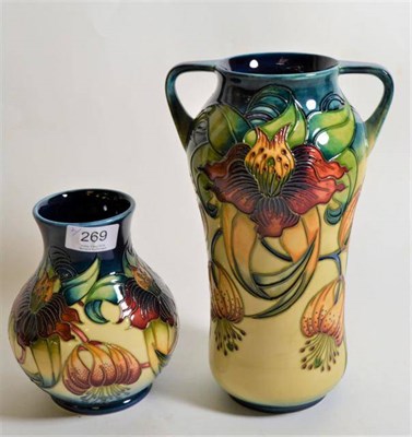 Lot 269 - Modern Moorcroft pottery: a twin handled 'Anna Lily' pattern vase 25cm and a baluster vase 15cm...