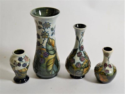 Lot 272 - Modern Moorcroft pottery: a group of four 'Bramble' pattern vases of various shapes and sizes...