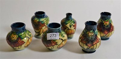 Lot 273 - Modern Moorcroft pottery: a group of six 'Anna Lily' pattern small vases designed by Nicola Slaney