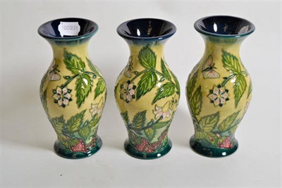 Lot 276 - Modern Moorcroft pottery: a set of three 'Fruit Garden' pattern vases designed by Nicola...