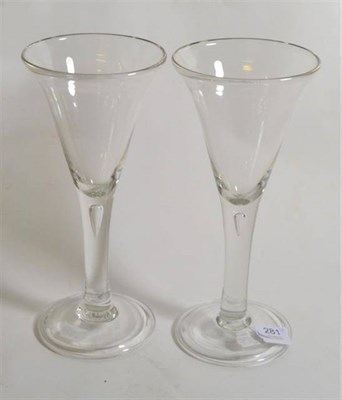 Lot 281 - A pair of glass goblets, mid-18th century, the conical bowls on plain stems with air tears, on...