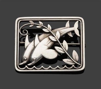 Lot 396 - A Brooch, by Georg Jensen, double dolphins diving into waves, with a leafy branch overlay within an