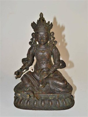 Lot 309 - A Tibetan bronze figure of Kubera with mongoose, 18th/19th century, 20cm high