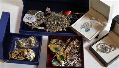 Lot 330 - A quantity of assorted costume jewellery to include Scottish brooches; a silver charm bracelet; and