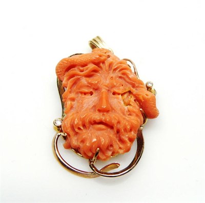 Lot 401 - A 9 Carat Gold Coral and Diamond Pendant, the coral carved realistically as a bearded man's...