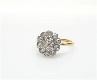 Lot 404 - A Diamond Cluster Ring, a round brilliant cut diamond within a border of smaller old brilliant...