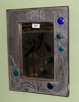 Lot 384 - A pewter and enamel mirror with foliate decoration and monogram