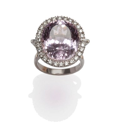 Lot 410 - An 18 Carat White Gold Kunzite and Diamond Cluster Ring, the oval cut kunzite within a border...