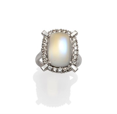 Lot 412 - A 14 Carat White Gold Moonstone and Diamond Cluster Ring, the cabochon moonstone within a border of