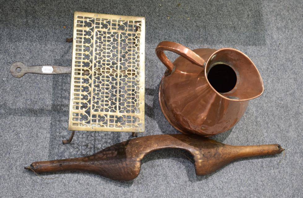 Lot 1156 - A two gallon copper harvest jug, a brass trivet and a wooden yoke (3)