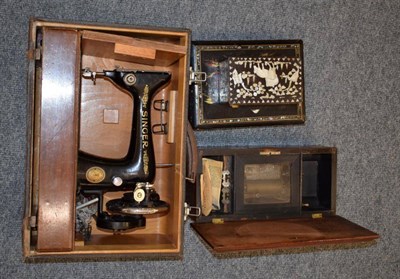 Lot 1158 - A small cylinder music box; a Singer sewing machine; and two jewellery boxes