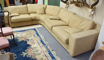 Lot 1230 - A corner sofa upholstered in oatmeal fabric