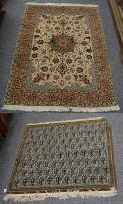 Lot 1237 - A Ghom rug decorated with boteh; together with an Indo-Persian silk rug, the central floral...
