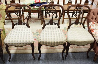 Lot 1241 - A set of three 19th century rosewood balloon back chairs, two footstools and two Victorian...