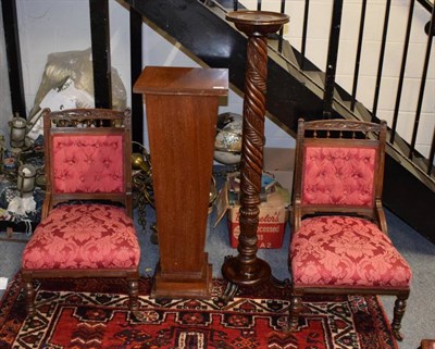 Lot 1247 - A mahogany pedestal; a pair of chairs and a torchere (4)