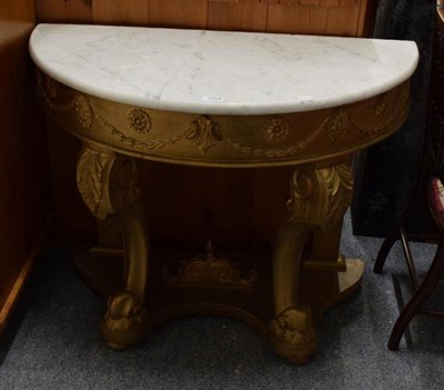 Lot 1254 - A reproduction marble topped demi-lune console table with gilt base