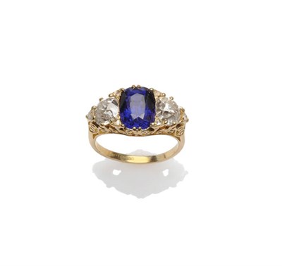 Lot 430 - An 18 Carat Gold Sapphire and Diamond Three Stone Ring, an oval cut sapphire flanked by an old...
