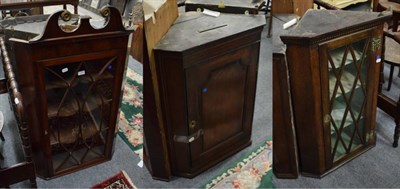 Lot 1266 - A George III glazed oak hanging corner cupboard, a George III panelled oak hanging corner...