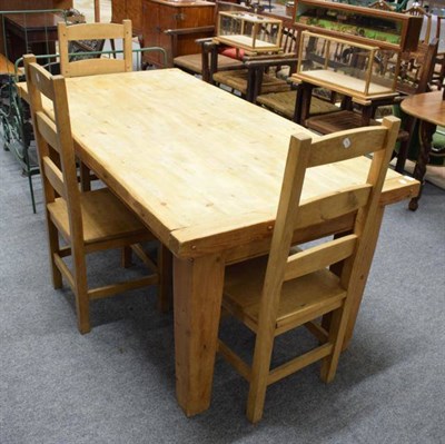 Lot 1277 - A Memory Lane pitch pine dining table and three matching chairs
