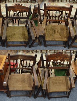 Lot 1282 - A matched set of four early 18th century armchairs, each with rush seats and carved crest rails