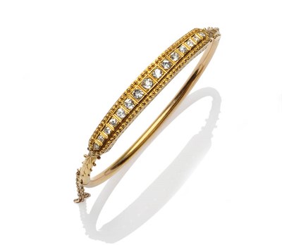 Lot 433 - A Victorian Diamond Set Bangle, a line of graduated old cut diamonds within a beaded fancy...