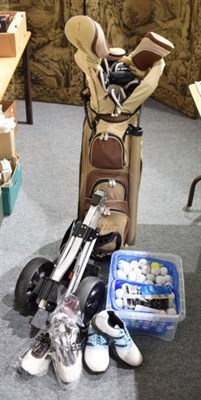 Lot 1296 - A bag of golf clubs, a trolley, a box of balls and two pairs of shoes