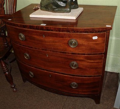 Lot 1302 - A George III mahogany bow fronted three height chest of drawers