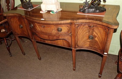 Lot 1304 - A mahogany serpentine fronted sideboard