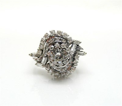 Lot 435 - A Diamond Cluster Ring, round brilliant cut, baguette cut and eight-cut diamonds in a swirl...