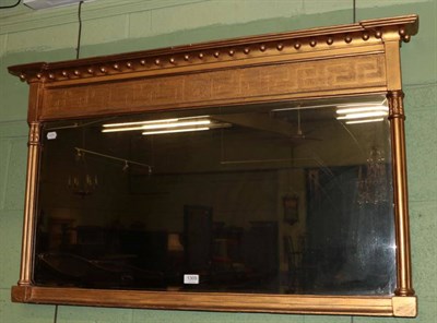 Lot 1309 - A regency inverted break front gilt framed mirror, the bevelled rectangular plate flanked by triple