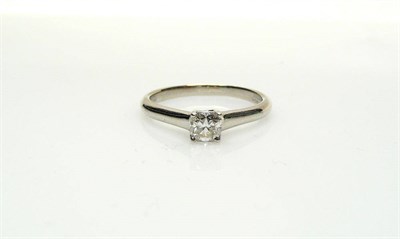 Lot 436 - A Diamond Solitaire Ring, by Tiffany & Co., a 'Lucida' cut diamond in a white four claw setting...