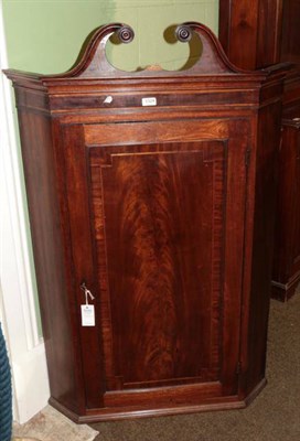 Lot 1324 - A George III mahogany wall hanging corner cupboard